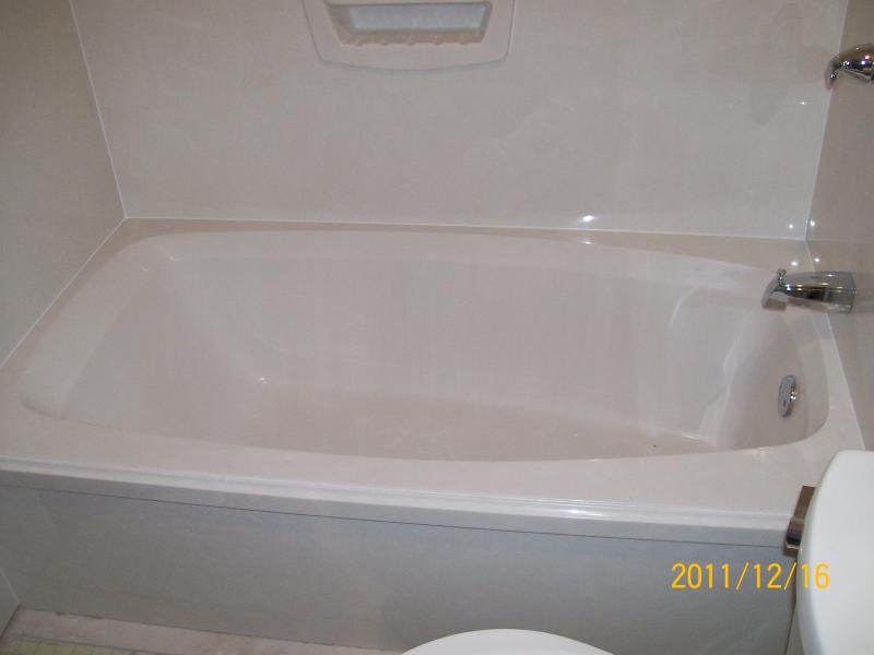 Cultured marble tub with large shampoo holder and new valve